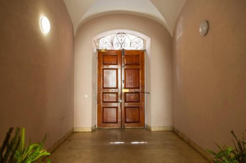a wooden door with a window in a room at Rome Lucia Apartment in Rome