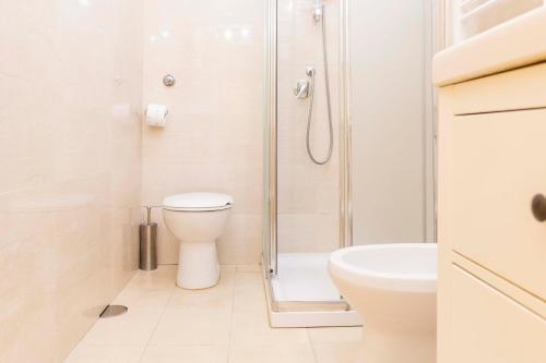 a bathroom with a shower and a toilet and a sink at Rome Lucia Apartment in Rome
