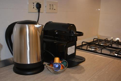 a coffee maker sitting on a counter next to a stove at Rome Lucia Apartment in Rome