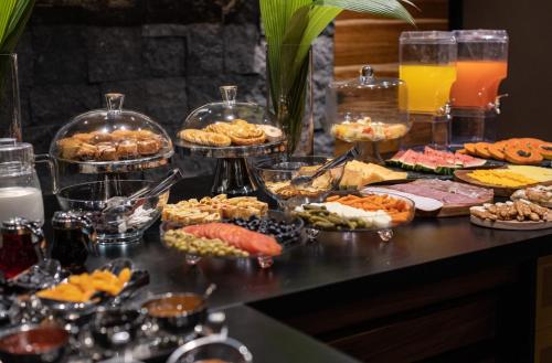 a table filled with different types of food and drinks at awā Beachfront Hotel in Puerto Viejo