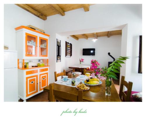 a kitchen and dining room with a table and chairs at La casetta in Dorgali