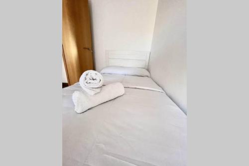 a small room with a bed with towels on it at APTO LOS MOLINOS LUCENA DEL CID Bajo C REF 048 in Lucena del Cid