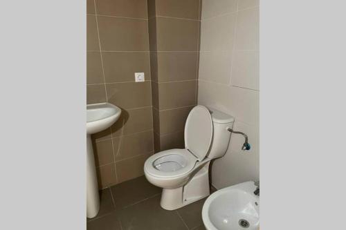a bathroom with a toilet and a sink at APTO LOS MOLINOS LUCENA DEL CID Bajo C REF 048 in Lucena del Cid