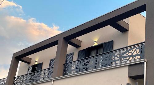 a building with a balcony with a blue sky at ALMA Bed & Breakfast in San Marco Argentano