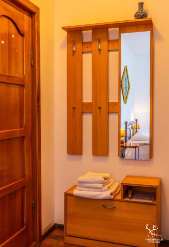a bathroom with a mirror and a wooden dresser at Pensiunea LIN COTA 1000 in Sinaia