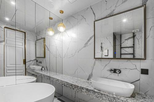 a white bathroom with two sinks and a mirror at Hotel the Castle bangi 2nd in Seoul