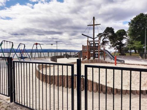 a park with a playground with a roller coaster at Firthview House in Kirn