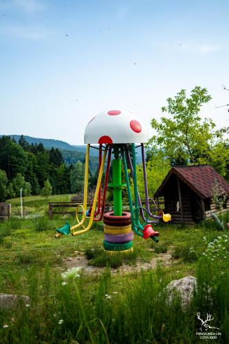 a playground in the middle of a field at Pensiunea LIN COTA 1000 in Sinaia