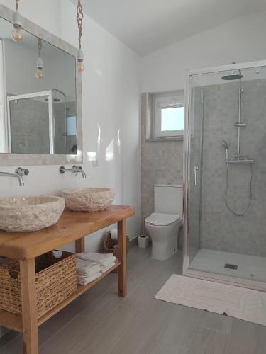 a bathroom with a shower and a sink and a toilet at Villa Vista in Sesimbra