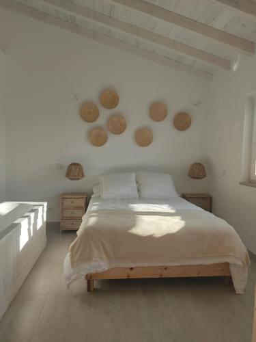 a bedroom with a large bed in a white room at Villa Vista in Sesimbra