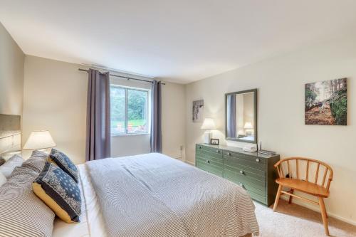 a bedroom with a bed and a dresser and a mirror at You, Me, & the Mountain in Warren
