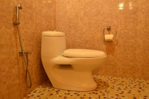 a bathroom with a toilet in a shower stall at Hotel Hermitage in Sauraha