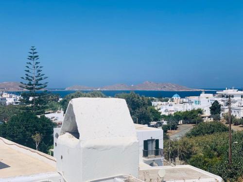 a white building with a view of a city at Lydia's Charming House in Naoussa in Naousa