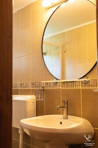 a bathroom with a sink and a mirror at Pensiunea LIN COTA 1000 in Sinaia