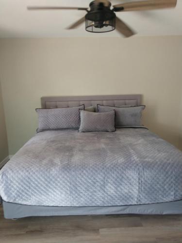 a bedroom with a bed with a ceiling fan at Red Rock Motel and Dam Motel in Page