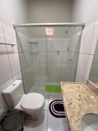 a bathroom with a toilet and a shower at Pousada Carmela in Icapuí