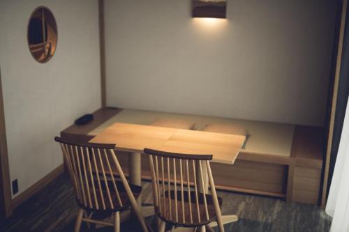 a small table with two chairs and a table with a desk at Tokyu Stay Hida Takayama Musubinoyu in Takayama