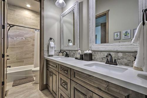 a bathroom with two sinks and a tub and a shower at Stylish Home with Expansive Deck in Show Low! in Show Low
