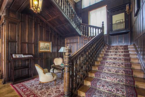 a staircase in a home with wood paneling at Seehotel Billroth in Sankt Gilgen