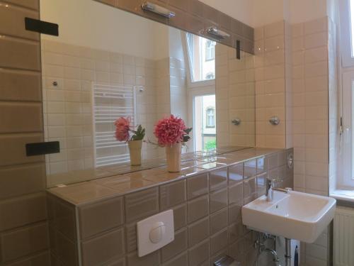 a bathroom with a sink and a mirror at Berlinapartments-Downtown in Berlin