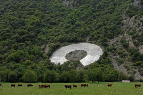 a group of cows grazing in a field with a mountain at Le Grand Chatelard HÔTEL BAR RESTAURANT in Sainte-Marie-de-Cuines