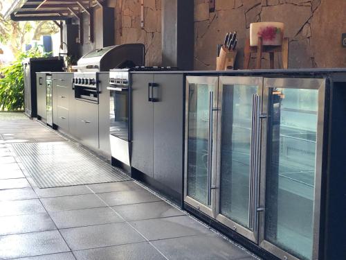 a row of glass doors on a sidewalk at Bali at the Bay in Nelson Bay