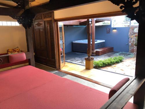 a room with a bed and a sliding glass door at Bali at the Bay in Nelson Bay