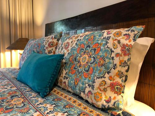 a bed with two pillows on top of it at Bali at the Bay in Nelson Bay