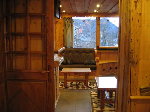 a living room with a couch and a table at Hôtel des Skieurs in Le Sappey-en-Chartreuse