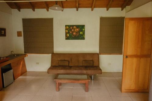 a living room with a couch and a picture of apples at Argovia Ecolodge in Tapachula