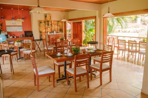 a dining room with wooden tables and chairs at Argovia Ecolodge in Tapachula