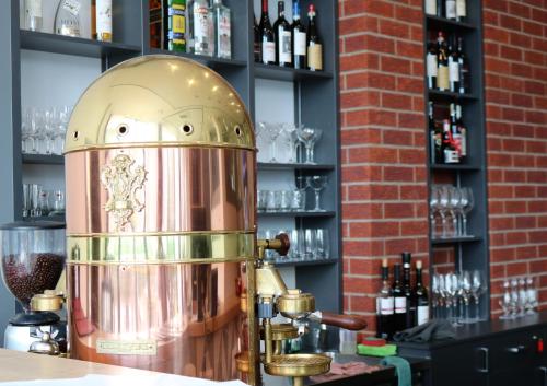 a drink machine sitting on a counter in a bar at Wellness Hotel Queens in Mariánské Lázně