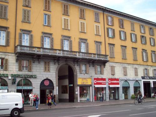 a large yellow building with a balcony on a street at B&B Smeraldo Airport in Bergamo