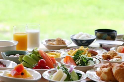 a table with plates of food and glasses of milk at Choyo Tei in Kamikawa