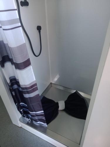 a bow tie in a box with a curtain at Four Peaks Motel in Geraldine