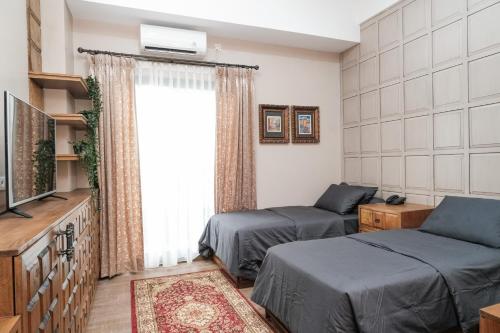 Postel nebo postele na pokoji v ubytování Nonies Huis Cibubur