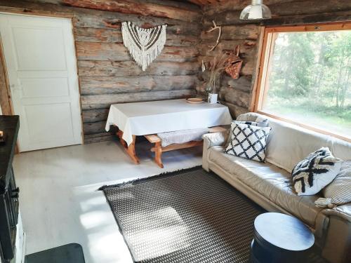 a living room with a couch and a table at Riemula cabin in Kuusamo