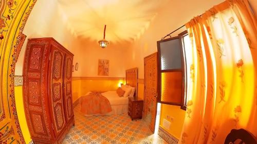 a bedroom with a bed and a large window at Riad Las Mil y una Noches Tetuan in Tetouan