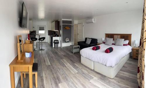 a bedroom with a large bed and a living room at 43 annexe in Newquay
