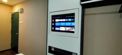 a television on a wall in a room at Smile Hotel Petaling Jaya SS2 in Petaling Jaya