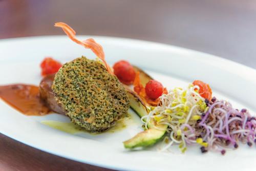 a white plate with food on a table at RETTER Bio-Natur-Resort in Pöllauberg