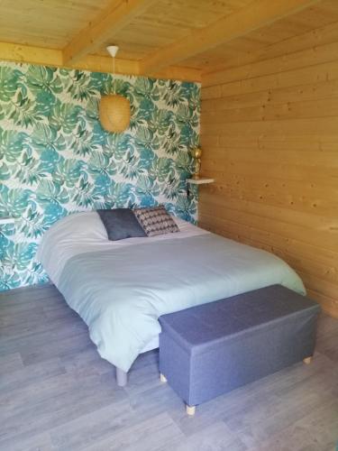 um quarto com uma cama num quarto de madeira em Moulin Room em Naours