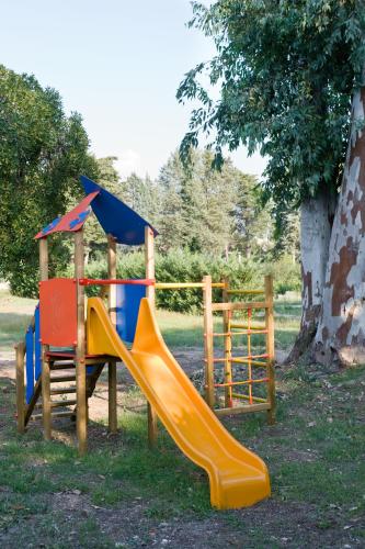 a playground with a slide and a fence at Agricola Samadhi in Zollino