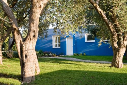 a blue house with trees in front of it at Agricola Samadhi in Zollino