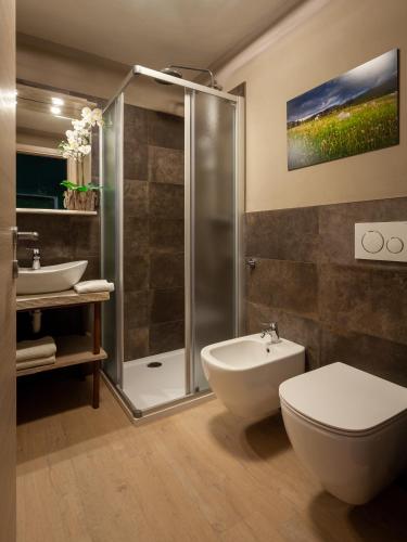 a bathroom with a shower and a toilet and a sink at Il Fauno in Asiago