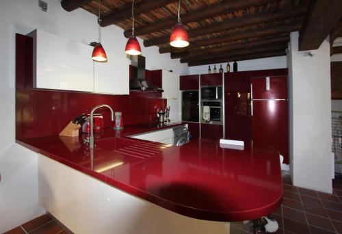 una cocina con encimera roja y electrodomésticos en River House, en Kakopetria