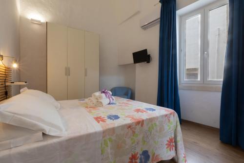 a bedroom with a bed with a teddy bear on it at B&B Dimora San Vincenzo in Gallipoli