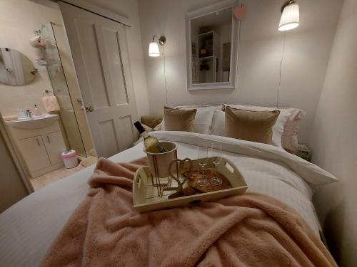 a bedroom with a bed with a tray of food on it at Hillside Cottage in Letterkenny