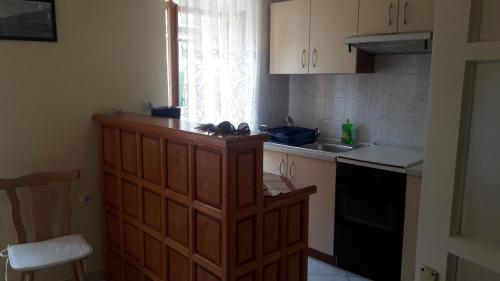 a kitchen with a wooden cabinet and a sink at Apartman Dinka in Baška