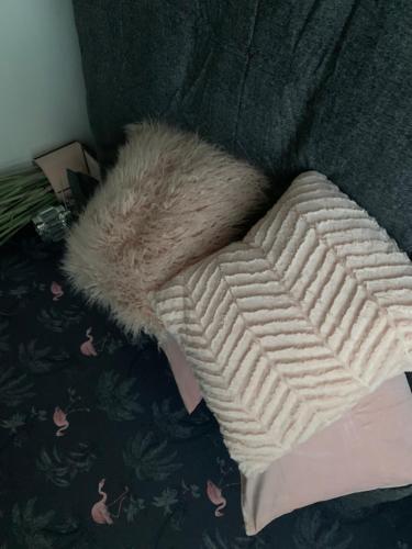 a furry pillow sitting on top of a couch at Shore Lodge. 4 bed bungalow only mtrs from the beach. Sleeps 8 in Sutton on Sea